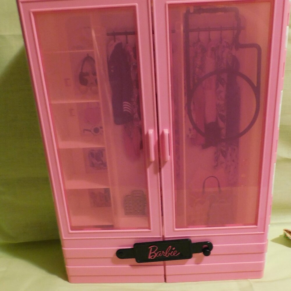 One Barbie doll with outfits pictured, accessories and Barbie doll closet